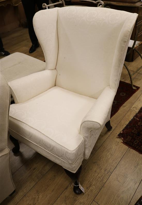 A modern upholstered wing armchair